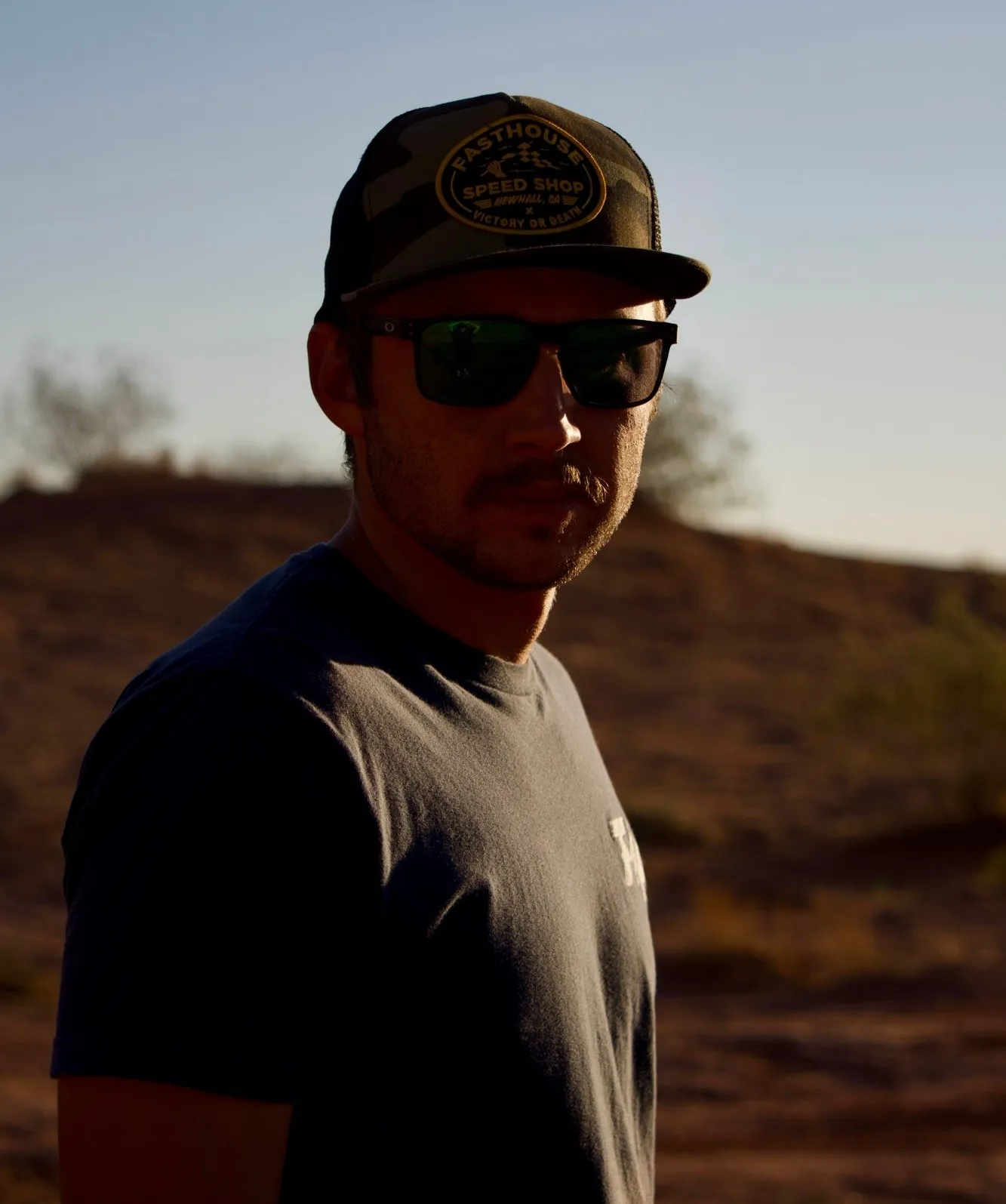 Portrait of Brock Reveal in a cap and sunglasses at sunset